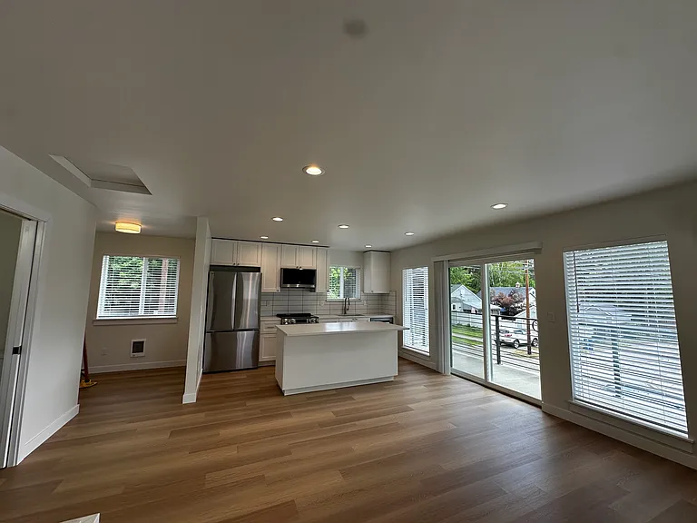 Small den/office, kitchen, slider to covered patio, and living room.