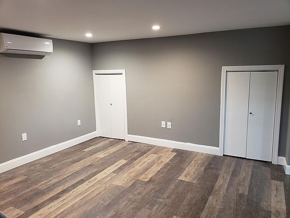 Living room features high efficiency Heat/Ac unit with wall mount remote control. Also, features 2 closets doors for storage access. Plenty of space to store plastic totes/bins.
