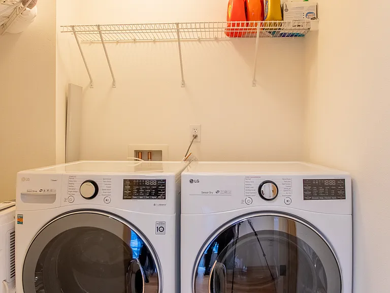 Enclosed laundry room with plenty of storage