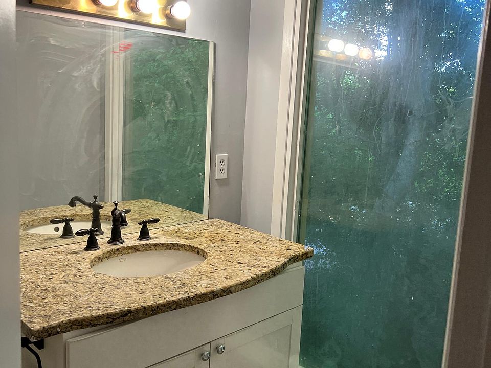 Full bathroom with large sunroom window