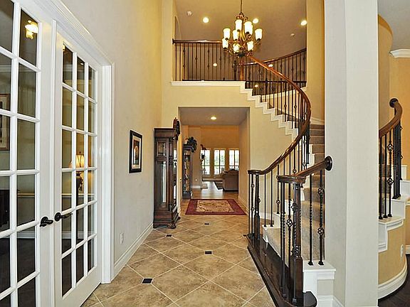 This is the impressive front entry with a sweeping staircase and tile floor with granite accents.