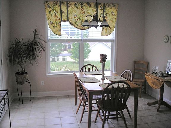 Large breakfast nook in kitchen overlooking backyard
