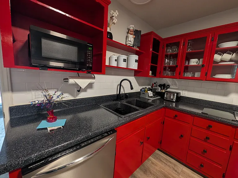 Dishwasher, Microwave, Sink, Knife set with cutting boards, Toaster, stove. Plenty of nice glassware & dishes.