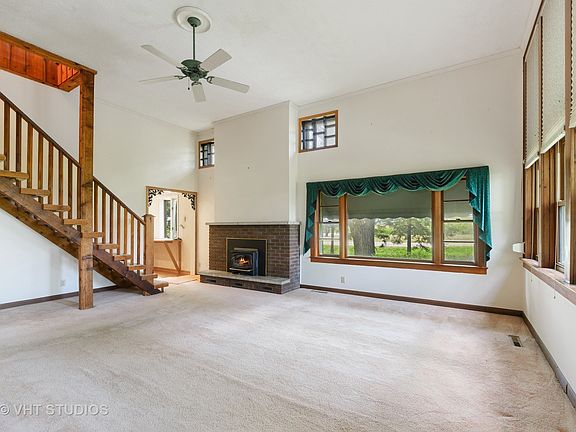 This is the living room with a fireplace and wonderful big windows and great views of the countrysid