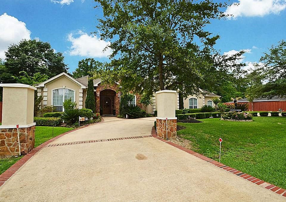 Take a moment to take a look as you pull up the brick accented circular drive to this gorgeous stucc