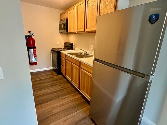 Galley style kitchen with stainless steel appliances