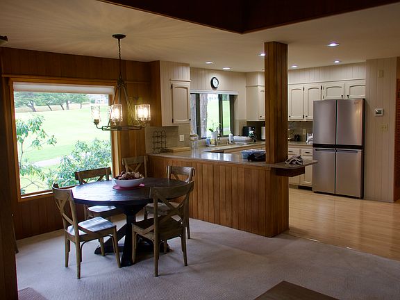 The dining table seats 6 and overlooks the golf course.
