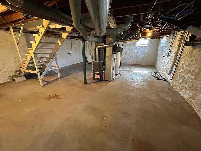 Large, unfinished basement with hook ups for washer and dryer.
