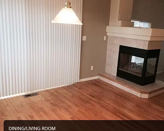 Dining room, patio door to the wood deck and fenced back yard. Tiled gas fireplace.
