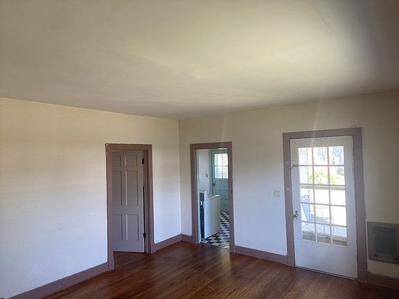 Living Room looking at main entry and kitchen door & bedroom door.