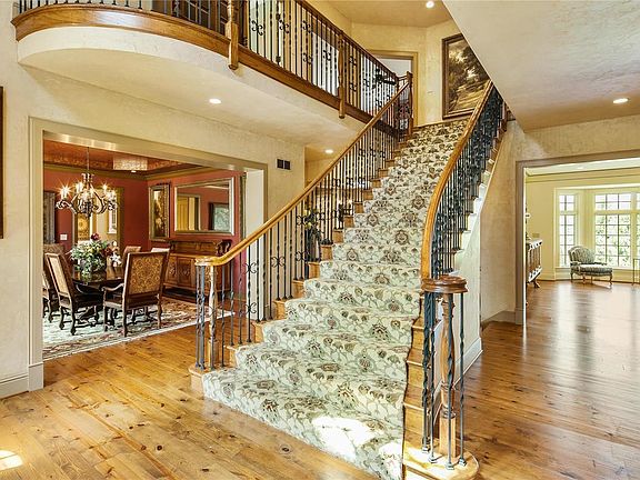 This grand, 2-story Entry features a wonderful 8 ft wide staircase at its base.  Venietian plaster accents the walls and the ceilings!