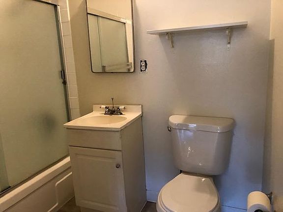 Bathroom with enclosed shower, toilet and sink