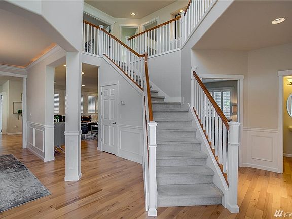 Welcome home to this light-filled, 2-story entry with open staircase, formal wainscot and hardwood floors throughout the main floor.