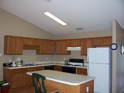 Lots of cabinets and has an island with additional cabinets.