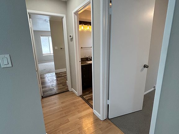 Hallway leading to bedroom #1, common bathroom, and primary bed/bathroom