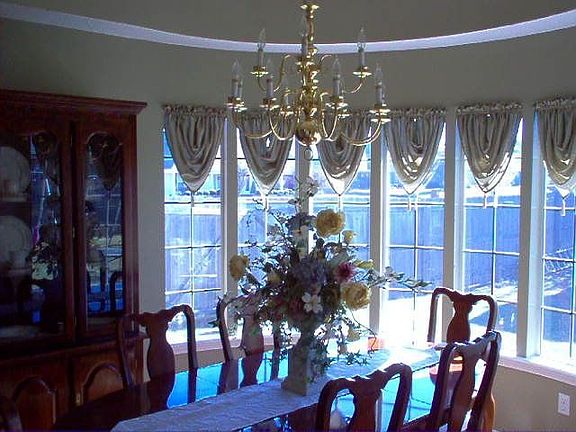 View into the dining rm with curved wall..Drop ceiling..Hardwood floors..