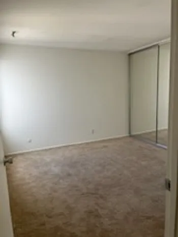Large bedroom with a window.
