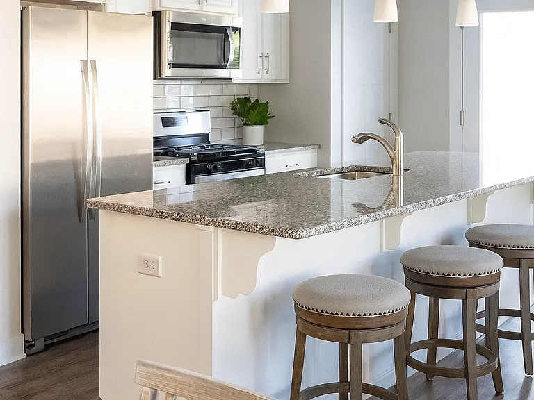 Modern kitchen with stainless steel appliances, granite countertops, and plenty of storage.