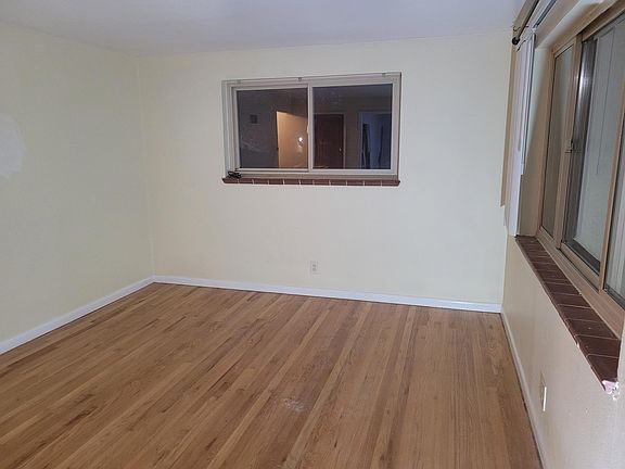 Living room view of front window and side window.
