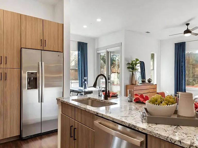 Kitchen with Stainless Steel Refrigerator and Built-In Pantry Cabinets