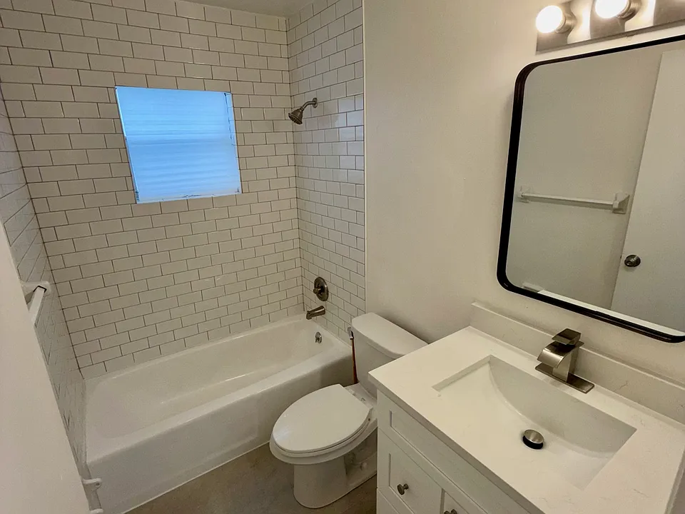 Refreshed bathroom with new tiles and sink