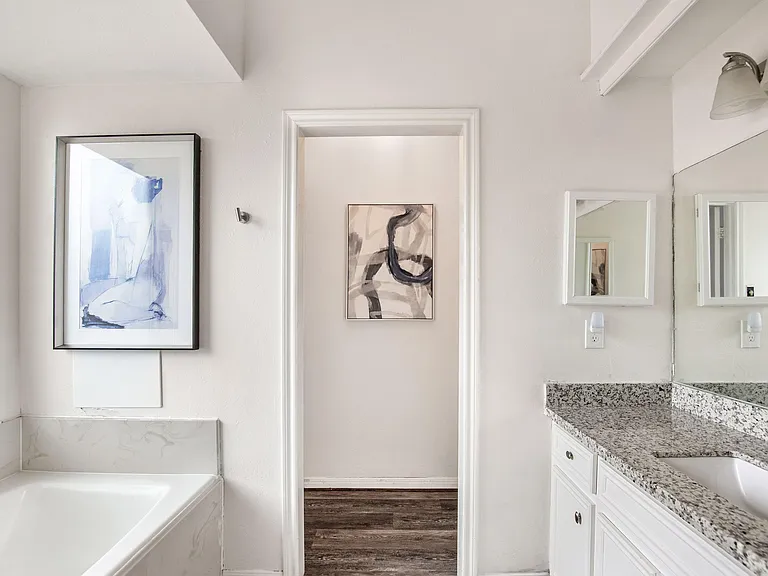 Private Bathroom with tub/shower combo, granite-look vanity countertop, and storage for everyday essentials.