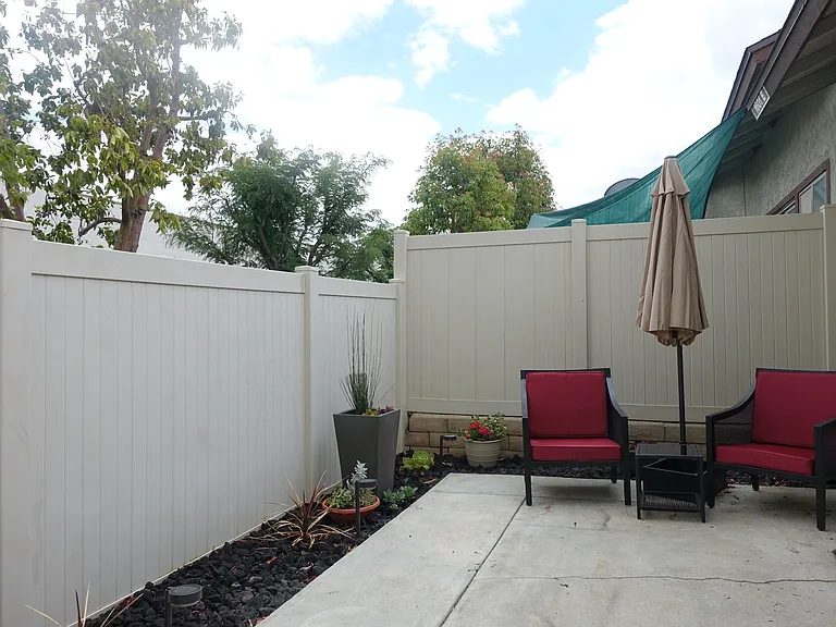 Enclosed Patio: Landscaped with pathway lights. Market umbrella and stand. Chairs and side table. Ring camera with floodlight.