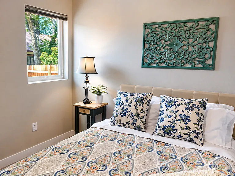 Large Queen-Size Bedroom. Room darkening, top-down/bottom-up shades. View of mountain range and big-trees.