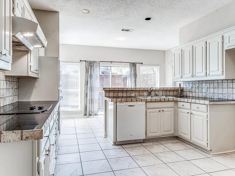 Kitchen with view into dining room.
Refrigerator being installed.