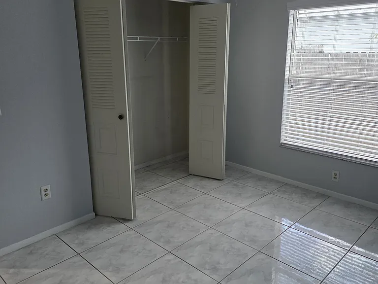 bedroom 1 from corner angle showing closet and window