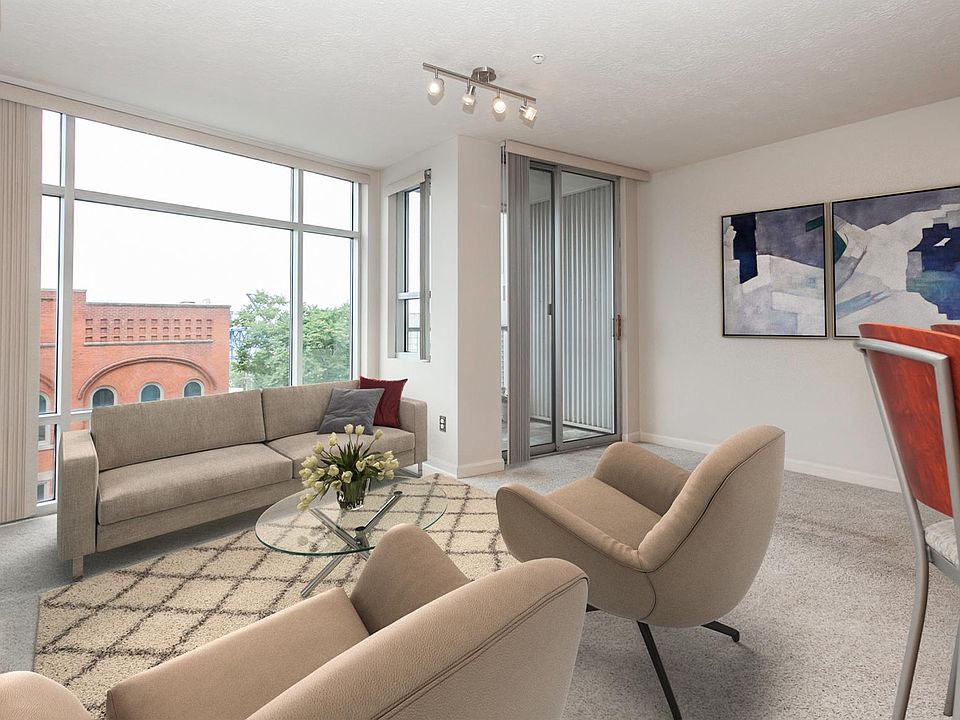 Spacious living room with floor to ceiling windows and balco
