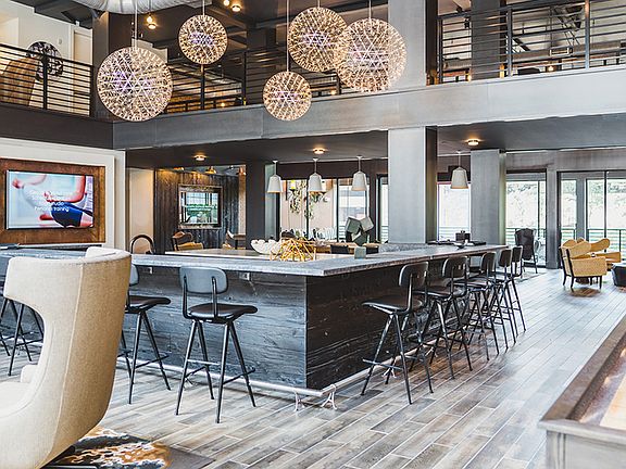 Upscale club room with entertainment kitchen, shuffleboard, ping pong, indoor-outdoor fireplace, and screened-in porch