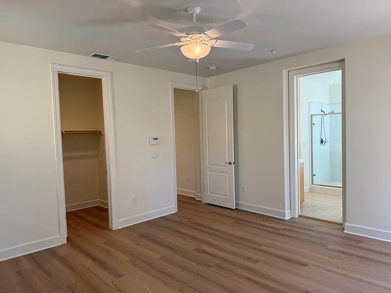 Primary bedroom has a patio door that opens a balcony overlooking the community green belt. Primary bedroom features 2 walk-in closets with tastefully appointed in-suite bathroom with 2 sinks, a whirlpool bathtub and a shower stall with glass enclosure.