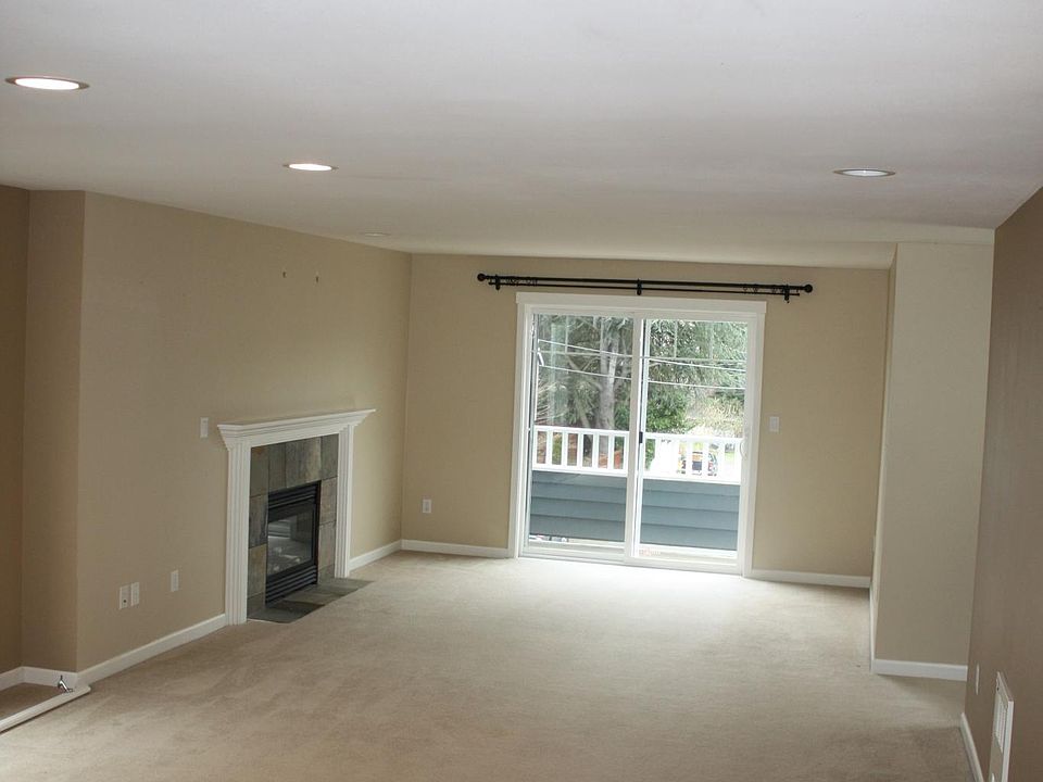 living space with fireplace and balcony