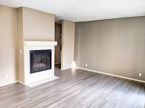 Cozy gas fireplace with mantle in living room - Westbrook Apartments