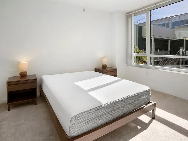 Furnished+ apartment homes feature queen bed with mattress, dresser, nightstands, and lamps (Representative Image exact items and style of furnishings may vary)