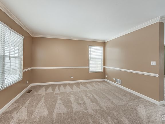 The crown molding and chair rail add some great elegance to this room.  The large windows also allow