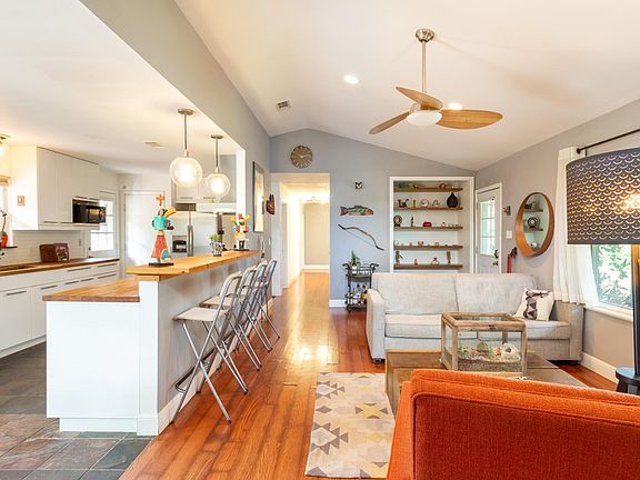 vaulted living area, open concept living/dining/kitchen. Wood laminate, hard tile in kitchen, no carpet!
