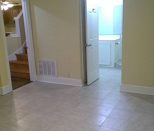 Den and entrance to full bathr