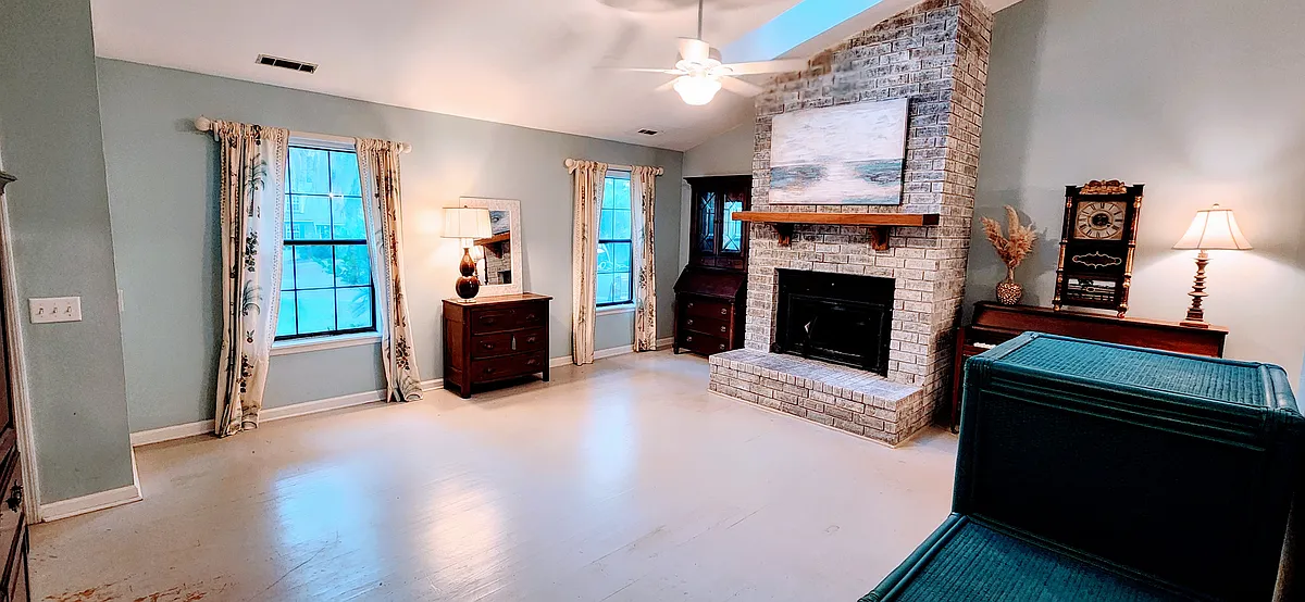 Living Room with gas fireplace and vaulted ceilings featuring two sun lights.. - 11 Abbey Ln