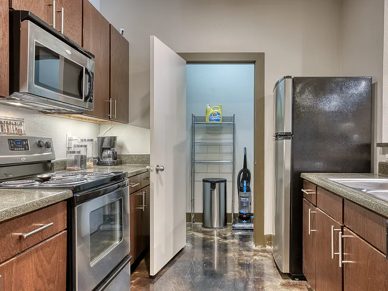 Modern Kitchen with Stainless Steel Appliances and Laundry Room