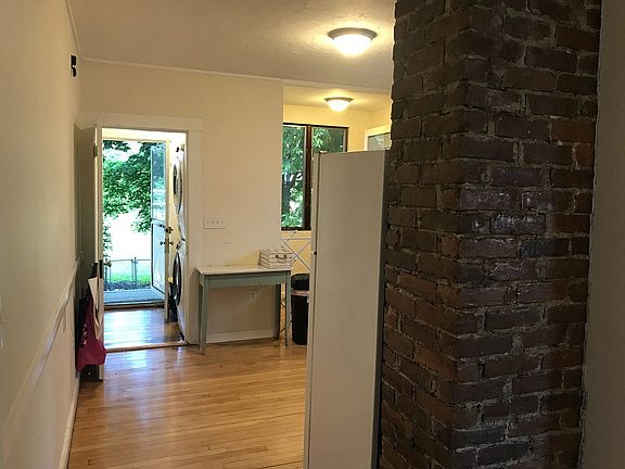 View from dining room through kitchen to laundry room and back door