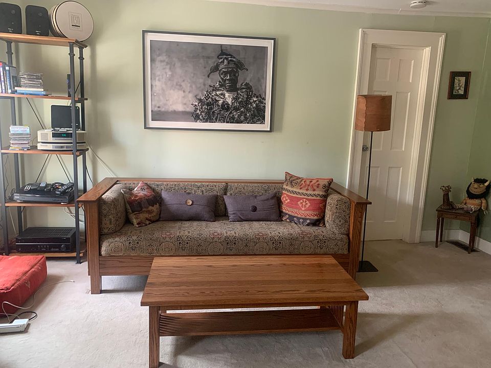 Living room. Door goes to Bedroom 2. There's a walk-in closet across from couch. Wool carpeting.