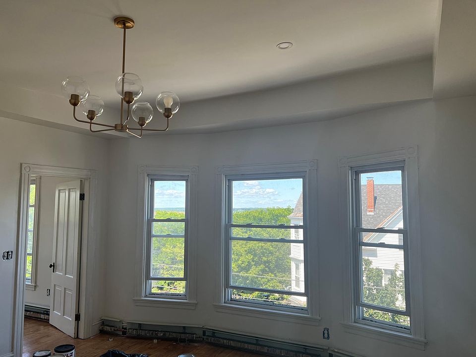 Living room with high ceilings, ocean glimpses in summer & views in winter