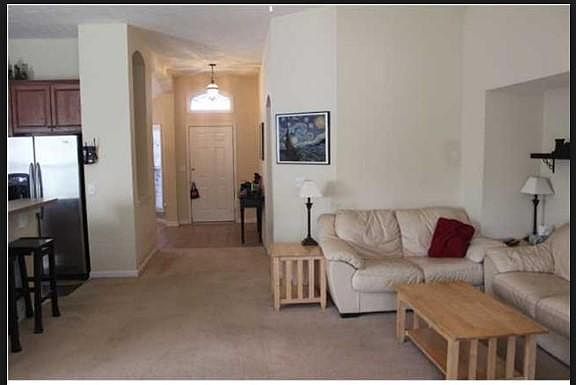 Stepping into the house thru white door, great room in the front