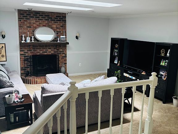 Family room with fireplace next to kitchen with access to gazebo