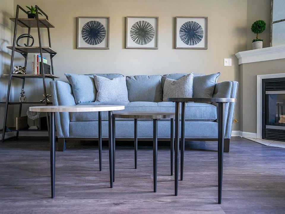 View of living area of great room showing corner fireplace & plank flooring