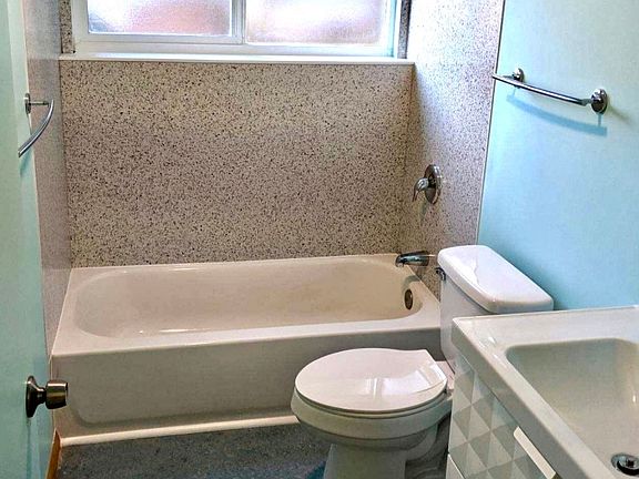 Bathroom with mid-century touches and natural light.