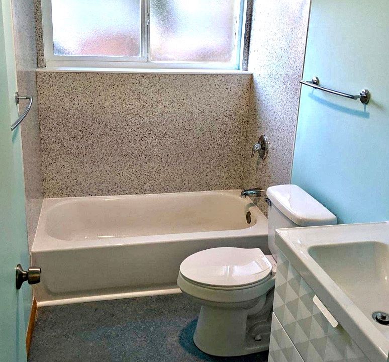 Bathroom with mid-century touches and natural light.