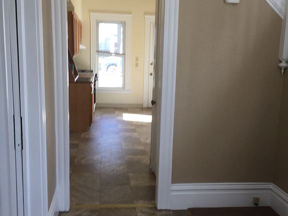 View from front door looking from entryway into kitchen, living room is on the left.